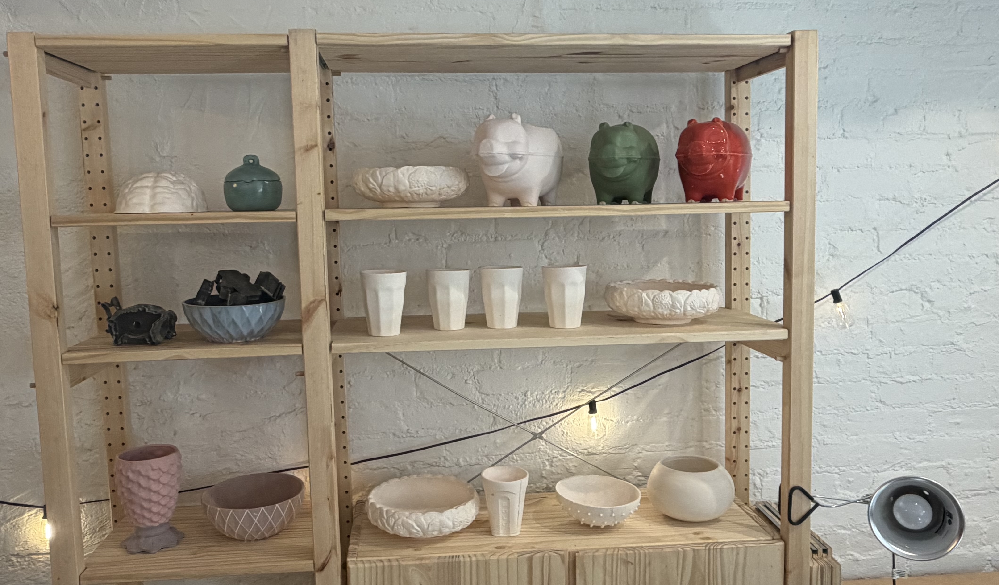 Finished pottery on studio shelving